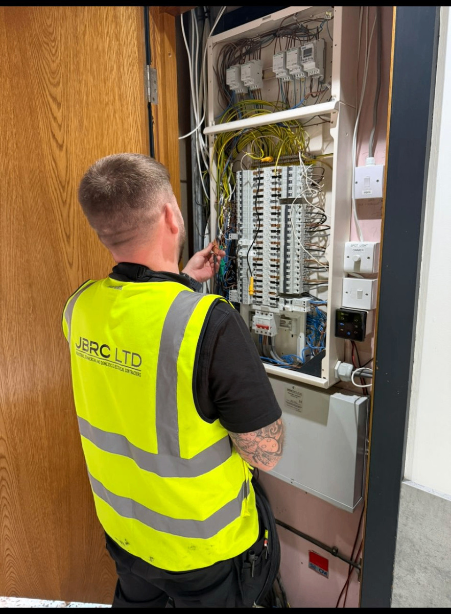 Commercial EICR being carried out at a Nottingham office distribution board, multifunction tester recording values
