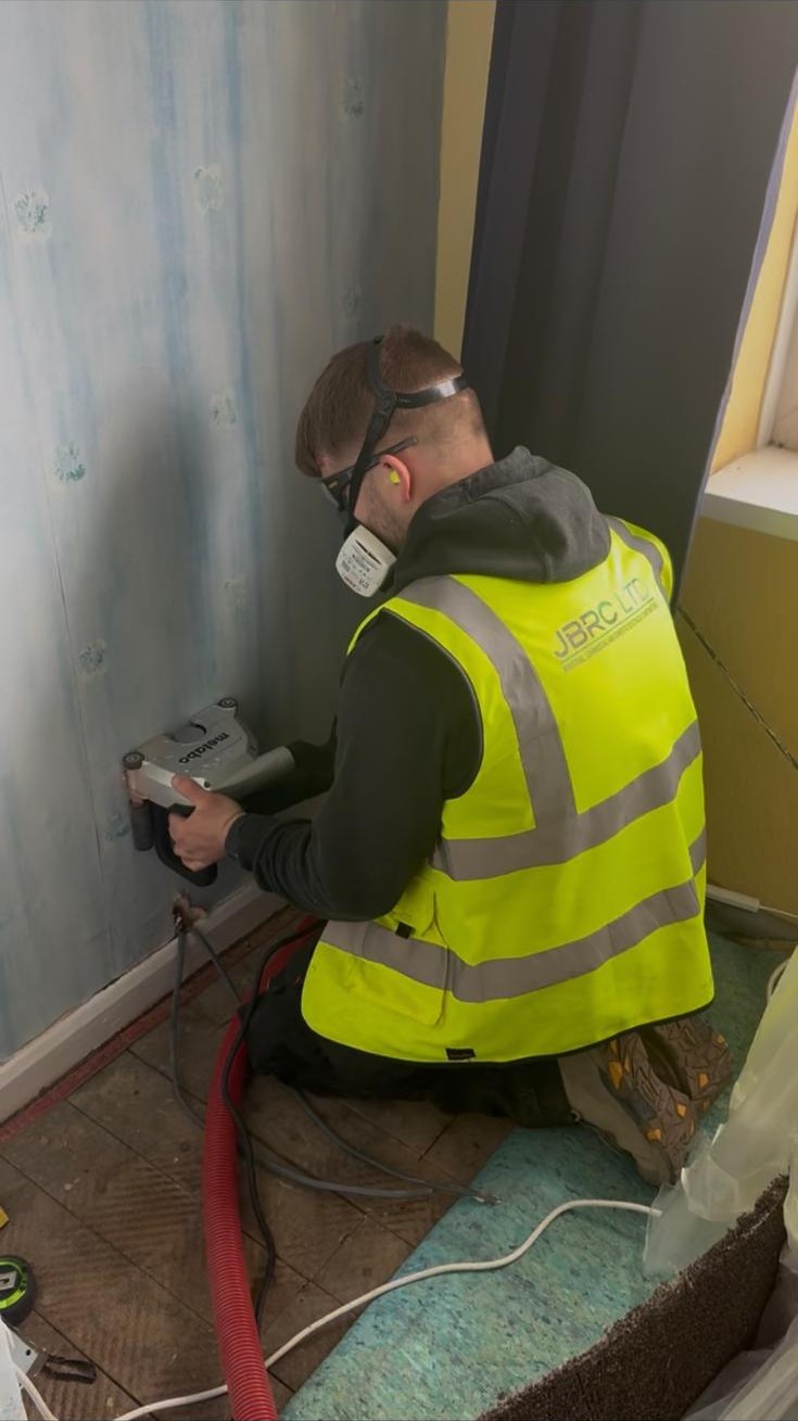 Electrician chasing new cable into a Nottingham semi during a full rewire